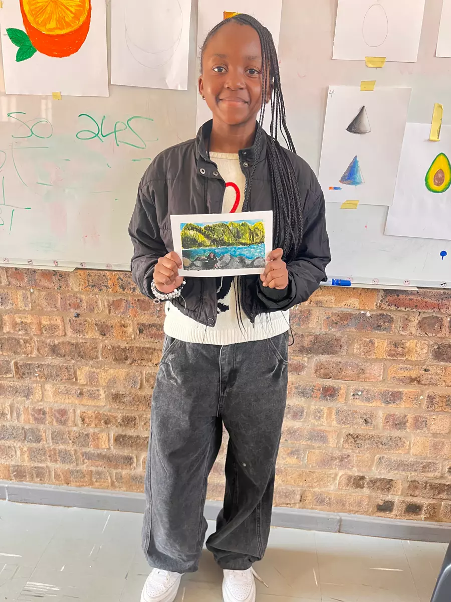 A young girl holding a painting
